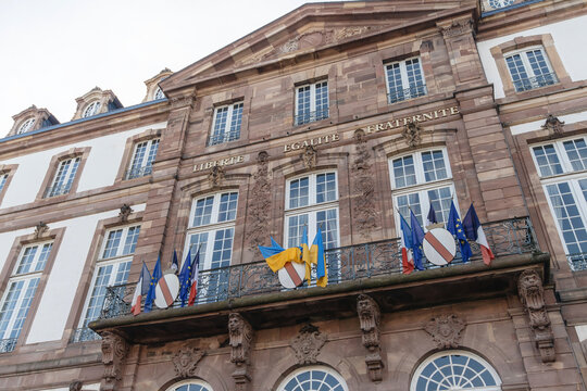 Liberte, Egalite, Fraternite inscription on the city-hall building in Strasbourg with Ukrainian National And French National flags waving on the facade