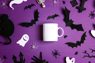 White coffee mug mockup for design, quote, brand or logo with Halloween decorations.