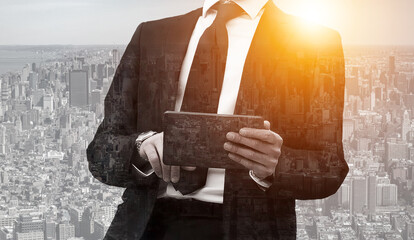 Businessman wearing black classic with tablet. Concept success with cityscape background. Double exposure.