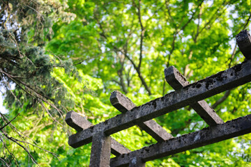 Japanese style pergola made from cement with green tree in the background