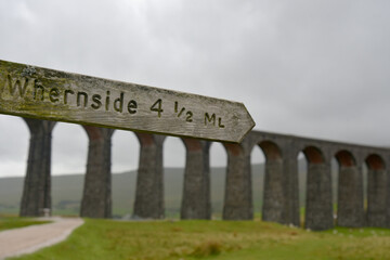 Fototapeta na wymiar Signpost beside Ribbleshead Viaduct in Yorkshire Dales