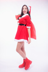 A dark-haired Asian woman in a red Santa Claus costume poses and looks at the camera, isolated on a white background. Add a message banner to sell items. shopping