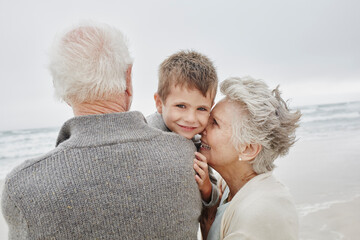 Happy grandparents spending quality time on the beach with grandson