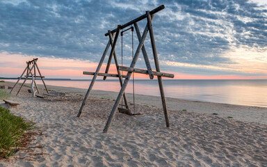 Coastal landscape at colorful dawn,  sandy beach of the Baltic Sea in Jurmala – famous international tourist resort in Latvia