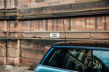 Reserve au personnel signage translated as reserved to authorised staff parking lot with part of a...