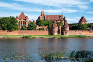 Fototapeta na wymiar The largest brick castle in the world - Malbork Castle on the Nogat River, Poland