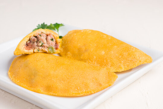 Patty filled with minced meat on light background