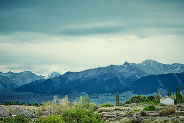 A small house against the backdrop of the great Tien Shan mountains on the southern shore of Issyk-Kul lake