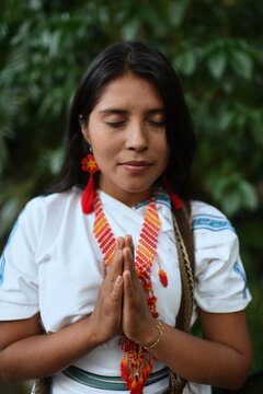 Young native Arhuaco woman in forest