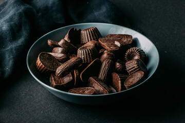 Bowl with yummy sweet chocolate candies served on table
