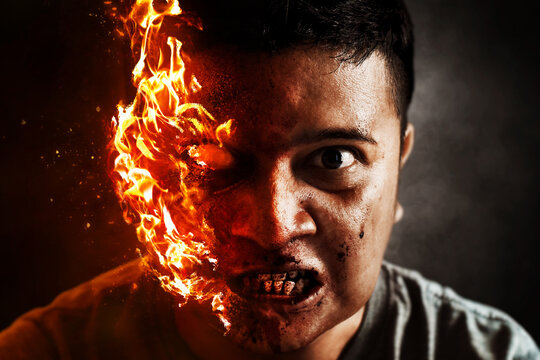 Devil man burning on dark background