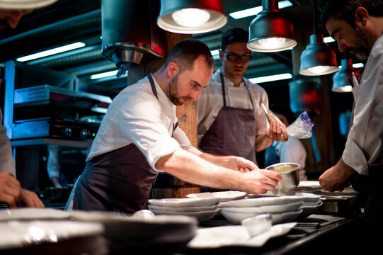 Cooks serving meal on restaurant kitchen