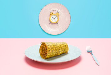 Two plates with an alarm clock and a centimeter tape, concept of intermittent fasting.
