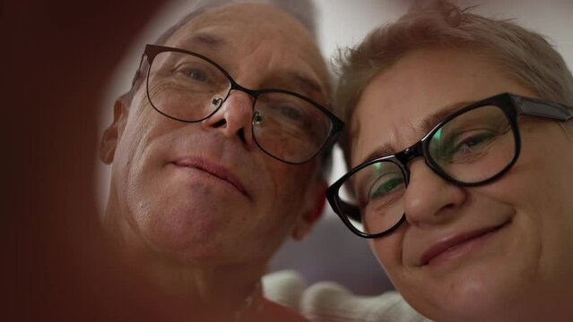 Portrait Of Older Retired Couple Making Heart With Their Hands