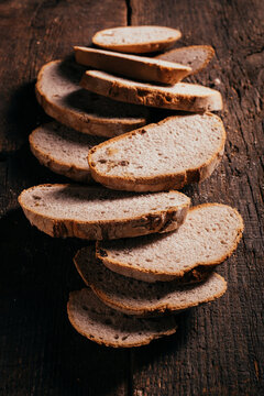 Sliced wholegrain bread scattered on wooden table