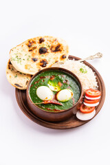 Spinach egg curry is an Indian non vegetarian dish made using palak gravy with eggs