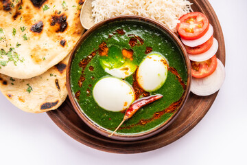 Spinach egg curry is an Indian non vegetarian dish made using palak gravy with eggs