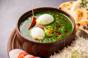 Spinach egg curry is an Indian non vegetarian dish made using palak gravy with eggs