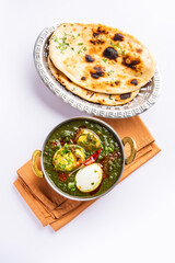 Spinach egg curry is an Indian non vegetarian dish made using palak gravy with eggs