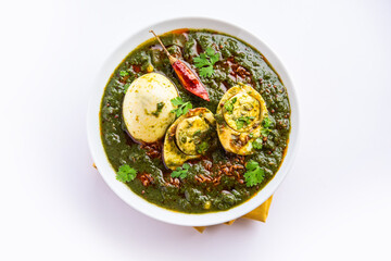 Spinach egg curry is an Indian non vegetarian dish made using palak gravy with eggs