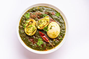 Spinach egg curry is an Indian non vegetarian dish made using palak gravy with eggs