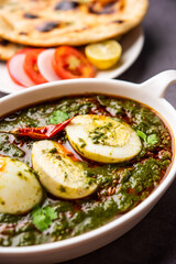 Spinach egg curry is an Indian non vegetarian dish made using palak gravy with eggs