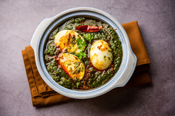 Spinach egg curry is an Indian non vegetarian dish made using palak gravy with eggs