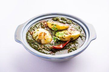 Spinach egg curry is an Indian non vegetarian dish made using palak gravy with eggs