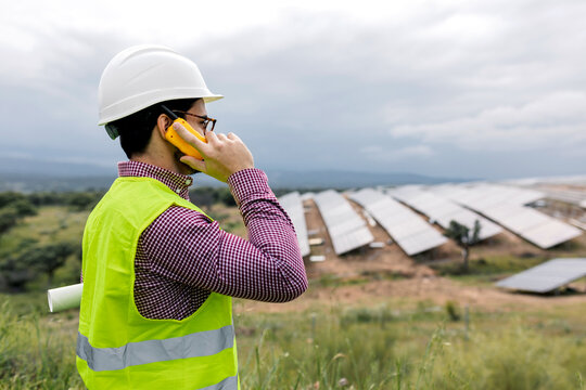 Foreman talking on radio near solar power plant