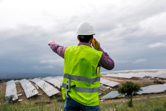 Anonymous foreman talking on radio near solar power plant