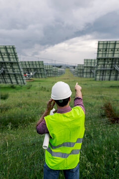 Anonymous foreman talking on radio near solar power plant