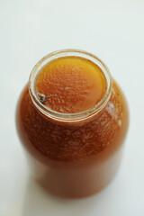 Glass jar of fresh natural fragrant honey with a bee