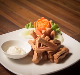 Fried sausage with mayonnaise sauce and fresh vegetables