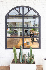 Fototapeta na wymiar Window with plant box in brick wall