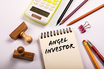 Angel investor. Stationery on a white office table
