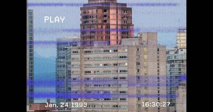 Animation of vhs glitch effect over tall buildings in background