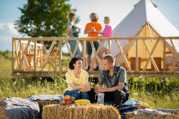 Great looking couple while sitting on the haystack in the middle of campsite they feeling romantic...