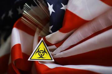 American flag and biohazard sign. The concept of American biolabs and research centers.