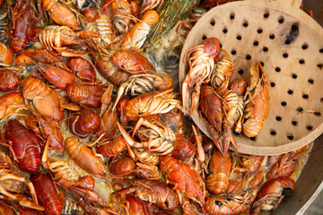 Boiled red crayfish or crawfish with herbs. Crayfish boiling in the pot on the fire