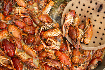 Boiled red crayfish or crawfish with herbs. Crayfish boiling in the pot on the fire