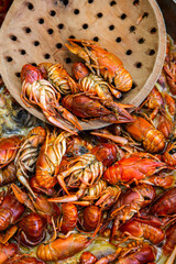 Boiled red crayfish or crawfish with herbs. Crayfish boiling in the pot on the fire
