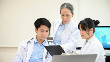 Fototapeta premium A team of Asian scientist planning and brainstorming on their Microbiology development research