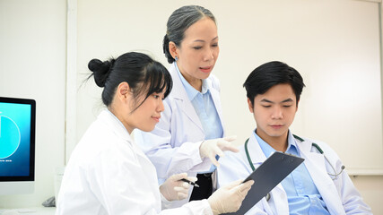 A team of professional Asian scientist discussing on their Pharmaceutical experiment research