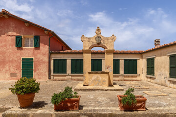 Small quiet square in the Portoferraio city center with an old marble well, Province of Livorno, Island of Elba, Italy