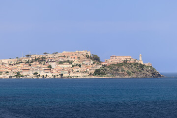 Panoramic view from the sea to Portoferraio city with its legendary buildings that made up its history - Forte Falcone, Forte Stella, and Lighthouse, Province of Livorno, Island of Elba, Italy