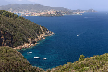 Fototapeta na wymiar One of numerous gulfs of Elba island with a panoramic view over the capital - Portoferraio and a series of distant capes and bays of the island, Province of Livorno, Italy