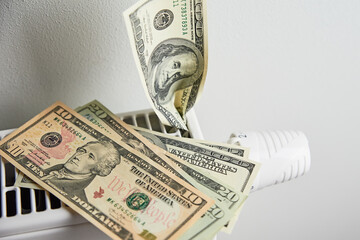 Heating radiator with dollar bills closeup, Energy crisis concept, Rising costs in private households for gas bill due to inflation and war