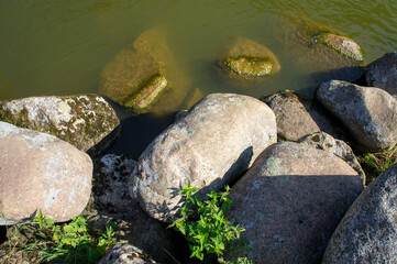 Naklejka na ściany i meble Large stones boulders near a mountain river