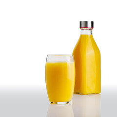 Glass of orange juice and orange juice bottles. Glass and bottle of organic tropical juice