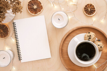 Back to life, goal list concept. Woman's hand writing in empty notebook on wooden table. Resolutions, plan, goals, checklist, idea concept. Top view, flat lay, copy space. 2022. Christmas, New Year